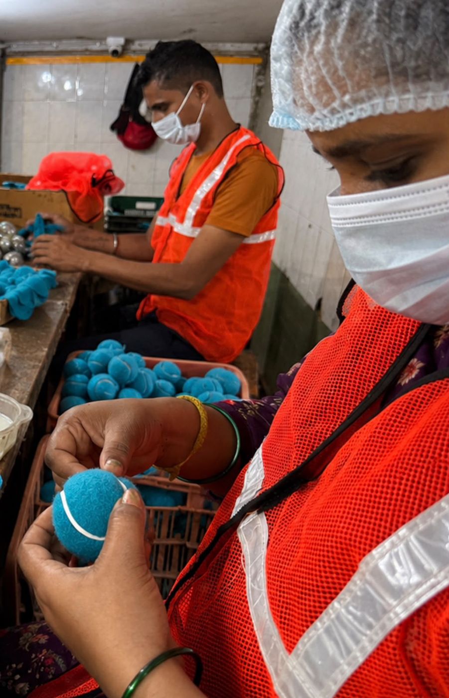 Worker applying the white rubber seam between felt panels
